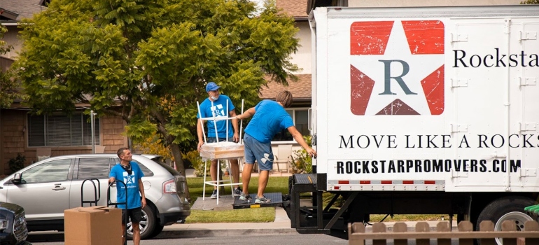 Cross country movers putting items into a moving truck