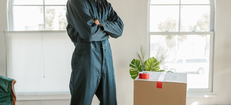 A man standing in a moving company uniform