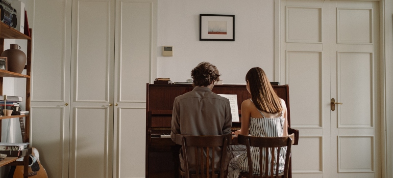couple playing after moving a piano in Los Angeles