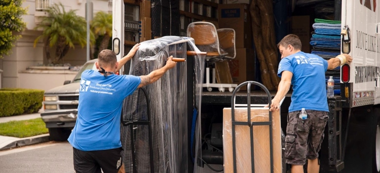 movers packing items into a moving truck