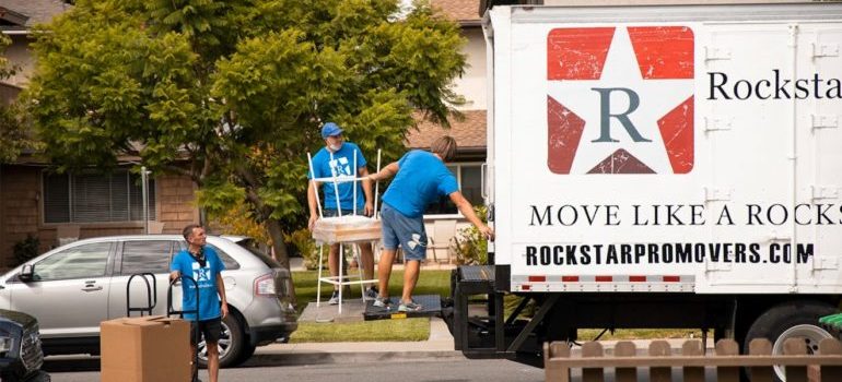 Orange County movers lifting furniture into a truck