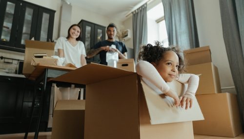 a family preparing to move playing with moving boxes