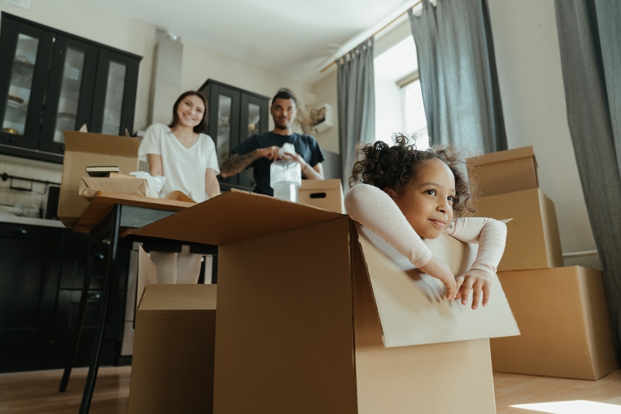 a family preparing to move playing with moving boxes