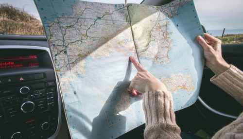 woman holding her finger on the map