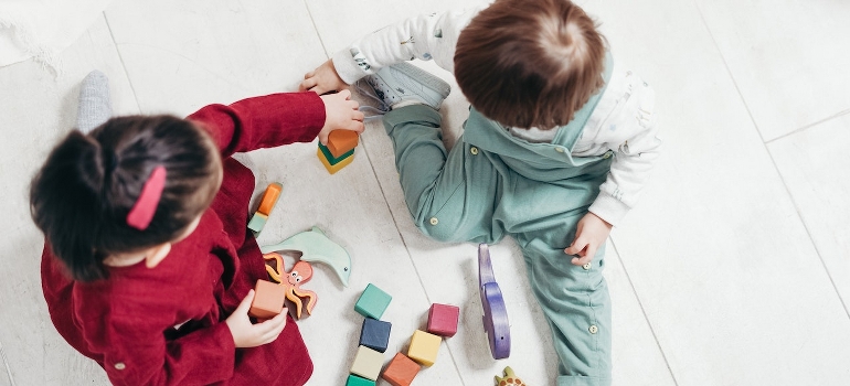 Two toddlers playing with lego blocks