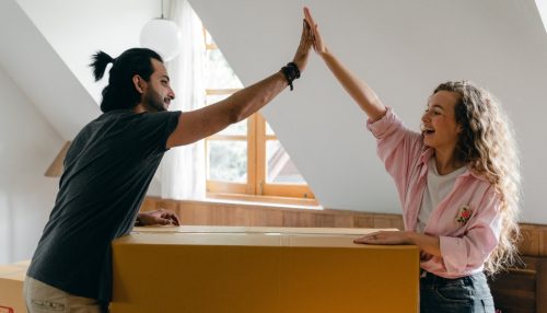 couple giving each other high five after successfully moving from Phoenix to San Diego