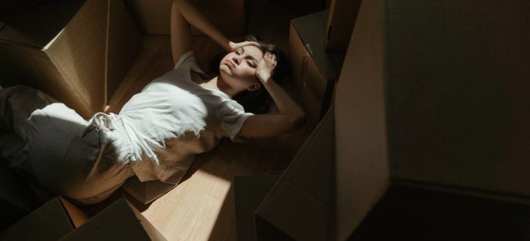 woman laying between boxes