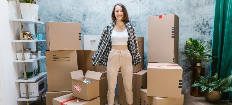 girl surrounded with moving boxes