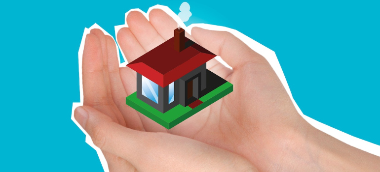hands holding a model of a house