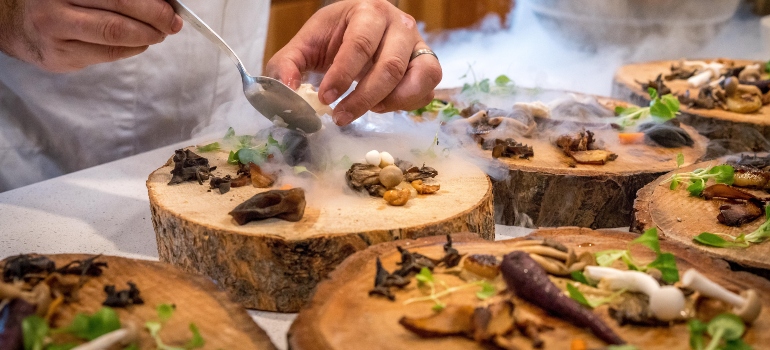 chef placing food on wooden plates