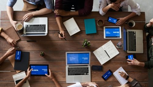 people with laptops sitting at a table