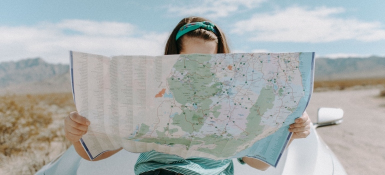 A woman with a map searching for the best places for young professionals in Orange County