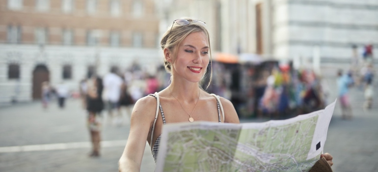 a woman holding a map as a guide to navigating LA's crazy traffic
