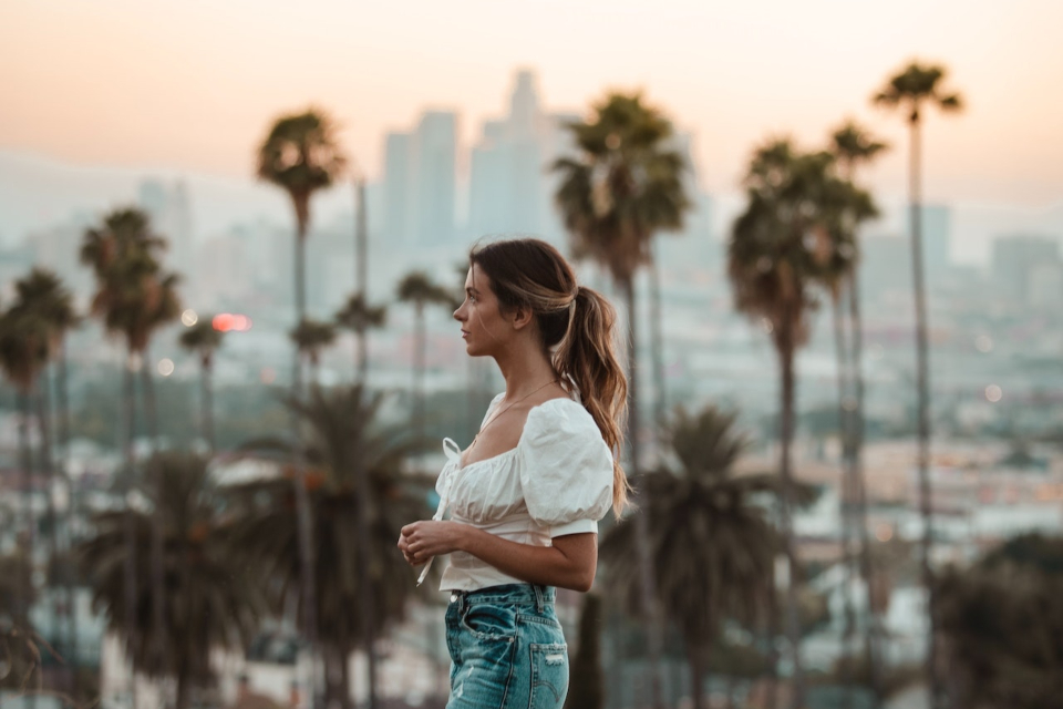 A woman standing in one of the busy streets of California