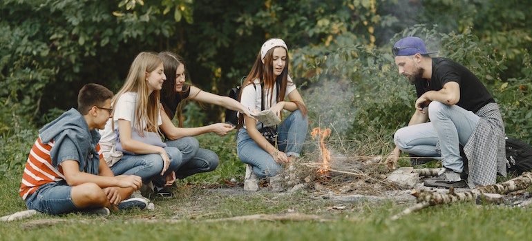 friends having fun in a park making a bonfire, surviving life in LA as a newcomer together