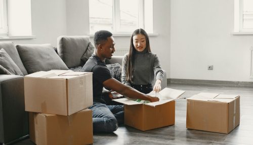 Picture of a couple siting next to boxes