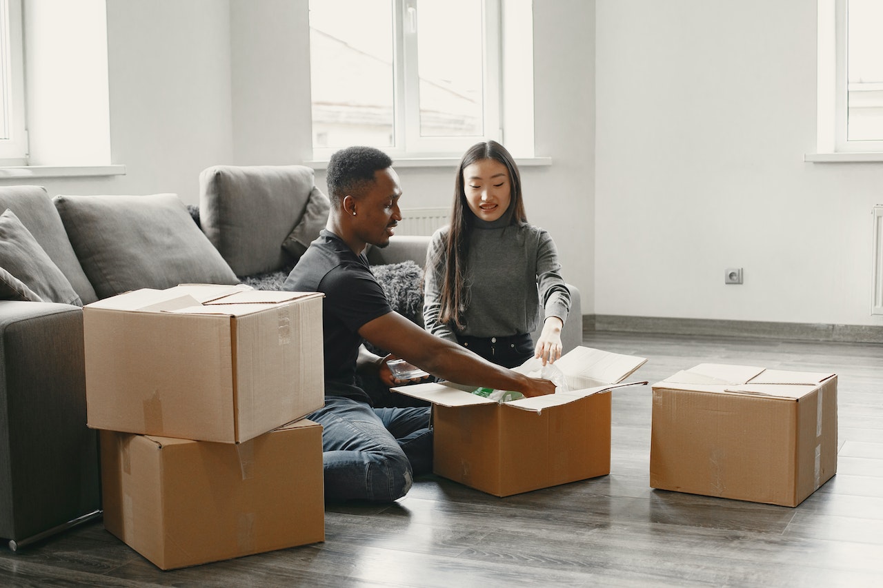 Picture of a couple siting next to boxes