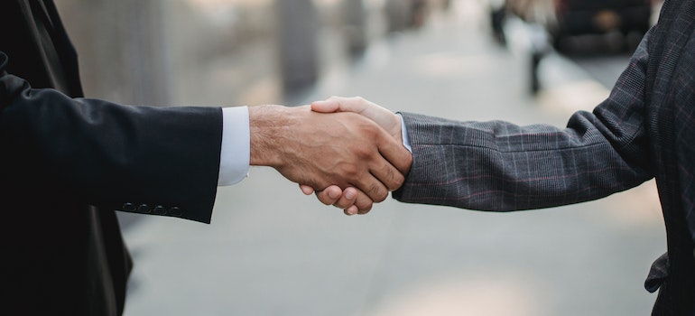 two men shaking hands just as you would with the seller after finding your dream home in LA